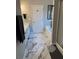 Bright bathroom featuring marble floors, dual vanity with sink, soaking tub, and a separate glass enclosed shower at 515 Sherwin Ct, Mcdonough, GA 30252