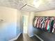 A well-lit walk-in closet with rods for hanging clothing, and an access panel on the ceiling at 515 Sherwin Ct, Mcdonough, GA 30252