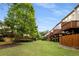 A row of townhomes featuring wooden decks and fenced backyards, set against lush green landscaping and a blue sky at 833 Charles Bank Se Ave, Atlanta, GA 30312