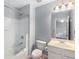 Bright bathroom features a combination tub and shower, a white vanity, and a toilet at 833 Charles Bank Se Ave, Atlanta, GA 30312
