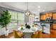 Sunlit dining area with hardwood floors, stylish pendant lighting, and modern decor at 833 Charles Bank Se Ave, Atlanta, GA 30312