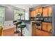 Eat-in kitchen bar area with stools, wooden cabinets, stainless steel appliances, and granite countertops at 833 Charles Bank Se Ave, Atlanta, GA 30312
