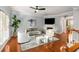 Bright living room with fireplace, ceiling fan, hardwood floors, and gray walls at 833 Charles Bank Se Ave, Atlanta, GA 30312