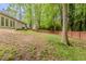 Fenced backyard with green grass and mature trees offers privacy and a natural landscape at 964 Chapman Ln, Stone Mountain, GA 30088