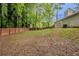 View of the large backyard with a dark wooden fence surrounding the property at 964 Chapman Ln, Stone Mountain, GA 30088