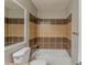 This bathroom includes a tub, shower with neutral tiled walls and an integrated mirror at 964 Chapman Ln, Stone Mountain, GA 30088