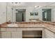 Bathroom with long countertop, white cabinets, and a large mirror reflecting into the next room at 964 Chapman Ln, Stone Mountain, GA 30088