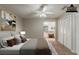 Staged bedroom featuring carpet, a ceiling fan, and ensuite bathroom access at 964 Chapman Ln, Stone Mountain, GA 30088