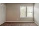Bright bedroom with carpet, closet, and a pair of windows that let in natural light at 964 Chapman Ln, Stone Mountain, GA 30088