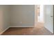 View of a carpeted bedroom with a doorway to the ensuite bathroom at 964 Chapman Ln, Stone Mountain, GA 30088