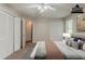 Staged bedroom with carpet, ceiling fan, dual closets and view of ensuite bath at 964 Chapman Ln, Stone Mountain, GA 30088