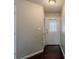 Hallway featuring a white front door with decorative glass, a light fixture, and a closet at 964 Chapman Ln, Stone Mountain, GA 30088