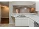 Kitchen featuring white countertops and cabinets with an open view to the living area and fireplace at 964 Chapman Ln, Stone Mountain, GA 30088