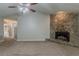 Living room with a stone fireplace and access to a bathroom, features carpeted flooring throughout at 964 Chapman Ln, Stone Mountain, GA 30088