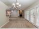 Open-concept space with a stone fireplace, French doors, and an adjacent kitchen area with a breakfast bar at 964 Chapman Ln, Stone Mountain, GA 30088