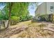 Large backyard featuring mature trees, privacy fence and gently sloping yard at 182 Garden Manor Ct, Loganville, GA 30052