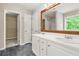 Bathroom featuring double sinks, a large mirror, and tile flooring at 182 Garden Manor Ct, Loganville, GA 30052