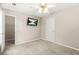 Neutral bedroom with a ceiling fan, walk-in closet and TV mounted on the wall at 182 Garden Manor Ct, Loganville, GA 30052