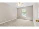 Cozy bedroom with a window bringing in natural light and neutral carpeting at 182 Garden Manor Ct, Loganville, GA 30052