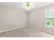 Bedroom featuring a ceiling fan and window with natural light at 182 Garden Manor Ct, Loganville, GA 30052