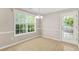 Bright dining area with large window and glass door at 182 Garden Manor Ct, Loganville, GA 30052