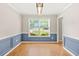 Bright dining area with blue wainscoting, wood floors and a large window at 182 Garden Manor Ct, Loganville, GA 30052