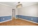 Elegant dining room with wood floors, wainscoting, and a modern chandelier, creating a sophisticated ambiance at 182 Garden Manor Ct, Loganville, GA 30052