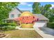 Charming two-story home with well-manicured landscaping and an attached two-car garage at 182 Garden Manor Ct, Loganville, GA 30052