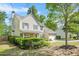 Charming two-story home with landscaped yard, complemented by lush greenery and a well-maintained lawn at 182 Garden Manor Ct, Loganville, GA 30052