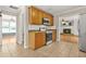 Cozy kitchen with modern appliances and wood cabinets, next to the living room at 182 Garden Manor Ct, Loganville, GA 30052