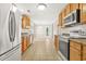 Functional kitchen with wood cabinets and modern appliances offers plenty of counter space for meal preparation at 182 Garden Manor Ct, Loganville, GA 30052