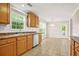 Functional kitchen with wooden cabinets, tile flooring, and modern appliances at 182 Garden Manor Ct, Loganville, GA 30052