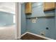 Practical laundry room features ample storage space and convenient utility connections for efficient chores at 182 Garden Manor Ct, Loganville, GA 30052