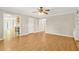 Open living space with wood floors and a view of the kitchen and stairway at 182 Garden Manor Ct, Loganville, GA 30052