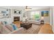 Bright living room with fireplace, built-in shelving, large windows, and comfortable seating at 182 Garden Manor Ct, Loganville, GA 30052