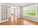 Bright living room featuring hardwood floors, natural light, and glass doors, offering a versatile space at 182 Garden Manor Ct, Loganville, GA 30052