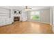 Bright living room featuring a stone fireplace and custom built-in shelving, perfect for cozy evenings at 182 Garden Manor Ct, Loganville, GA 30052