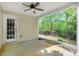 Covered patio featuring a ceiling fan overlooking the grassy backyard with privacy fence and mature trees at 182 Garden Manor Ct, Loganville, GA 30052