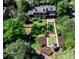Aerial view of a brick home with a manicured lawn, pond, and a gazebo at 2121 Ponce De Leon Ne Ave, Atlanta, GA 30307