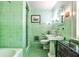 Vintage-style bathroom featuring mint green tiling and a walk-in shower at 2121 Ponce De Leon Ne Ave, Atlanta, GA 30307