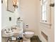 Quaint bathroom featuring a vintage-style sink, toilet, and fixtures with a window for natural light at 2121 Ponce De Leon Ne Ave, Atlanta, GA 30307