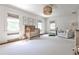 Sunlit Bedroom with a crib, neutral tones, and soft gray carpet at 2121 Ponce De Leon Ne Ave, Atlanta, GA 30307