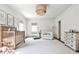 Bedroom featuring soft gray carpet, a crib, and neutral decor at 2121 Ponce De Leon Ne Ave, Atlanta, GA 30307