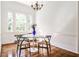 Bright dining area with a glass table, hardwood floors, and neutral walls at 2121 Ponce De Leon Ne Ave, Atlanta, GA 30307