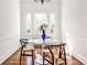 Bright dining area with a glass table, hardwood floors, and natural light at 2121 Ponce De Leon Ne Ave, Atlanta, GA 30307