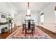 Dining room with hardwood floors, neutral walls, area rug, and modern lighting at 2121 Ponce De Leon Ne Ave, Atlanta, GA 30307