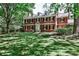 Beautiful two-story brick home with manicured lawn and mature trees, exuding classic charm and elegance at 2121 Ponce De Leon Ne Ave, Atlanta, GA 30307