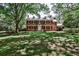 Stately two-story brick residence surrounded by mature trees and a spacious lawn, offering timeless appeal at 2121 Ponce De Leon Ne Ave, Atlanta, GA 30307