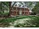 Charming brick home features a lush lawn and mature trees, offering a serene and inviting curb appeal at 2121 Ponce De Leon Ne Ave, Atlanta, GA 30307