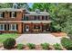 Charming brick home featuring a covered porch with dining area and manicured front yard at 2121 Ponce De Leon Ne Ave, Atlanta, GA 30307